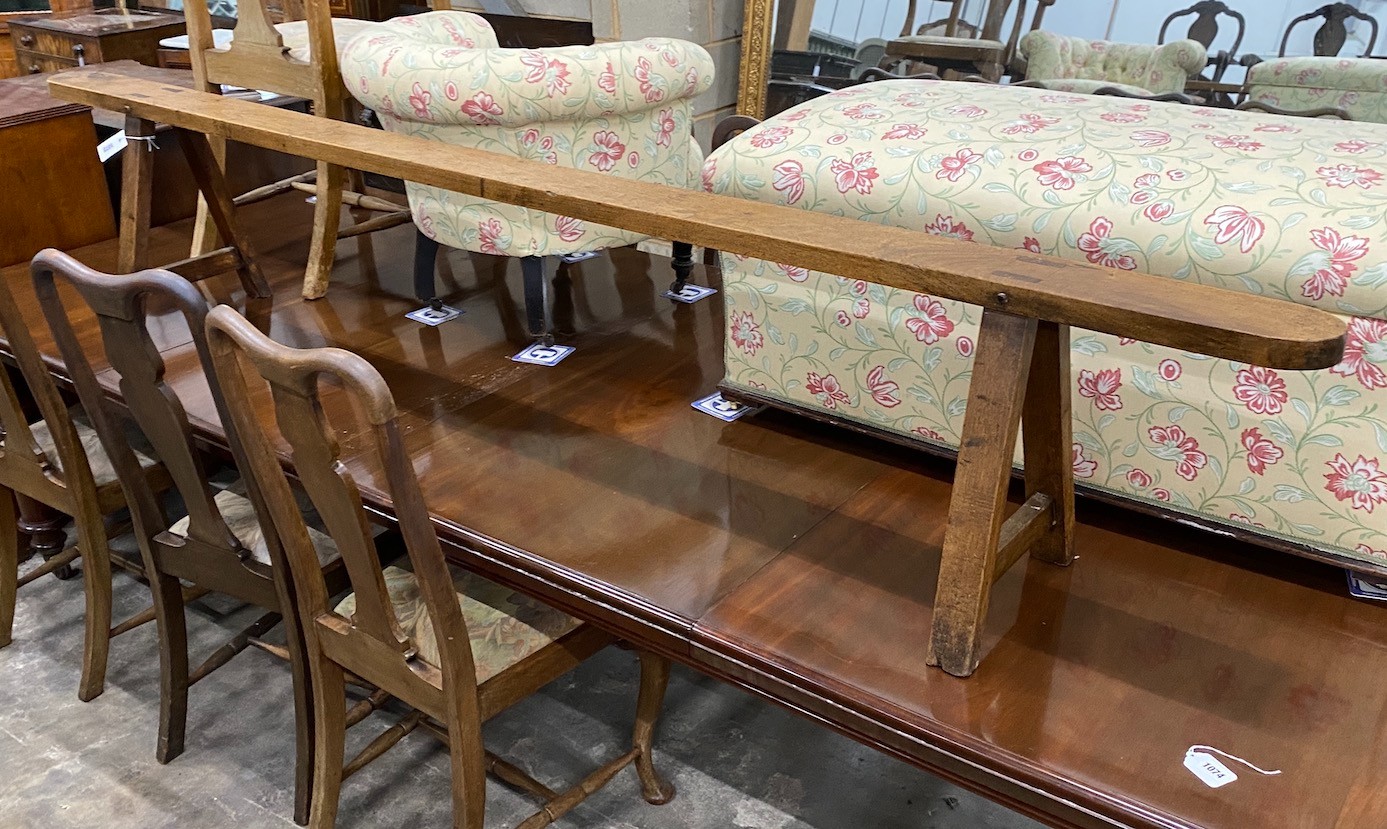 A late 18th / early 19th century provincial fruitwood bench seat, length 254cm, height 46cm